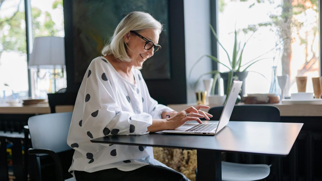 Middle-aged person learning new skills online to prepare for retirement